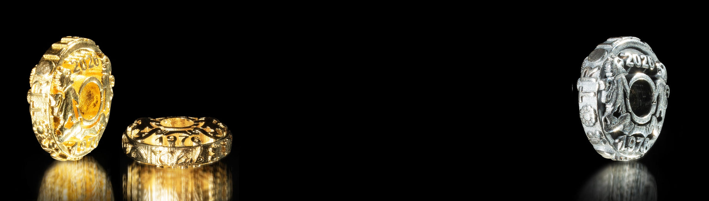 Three jewelry jubilee coins on a black background